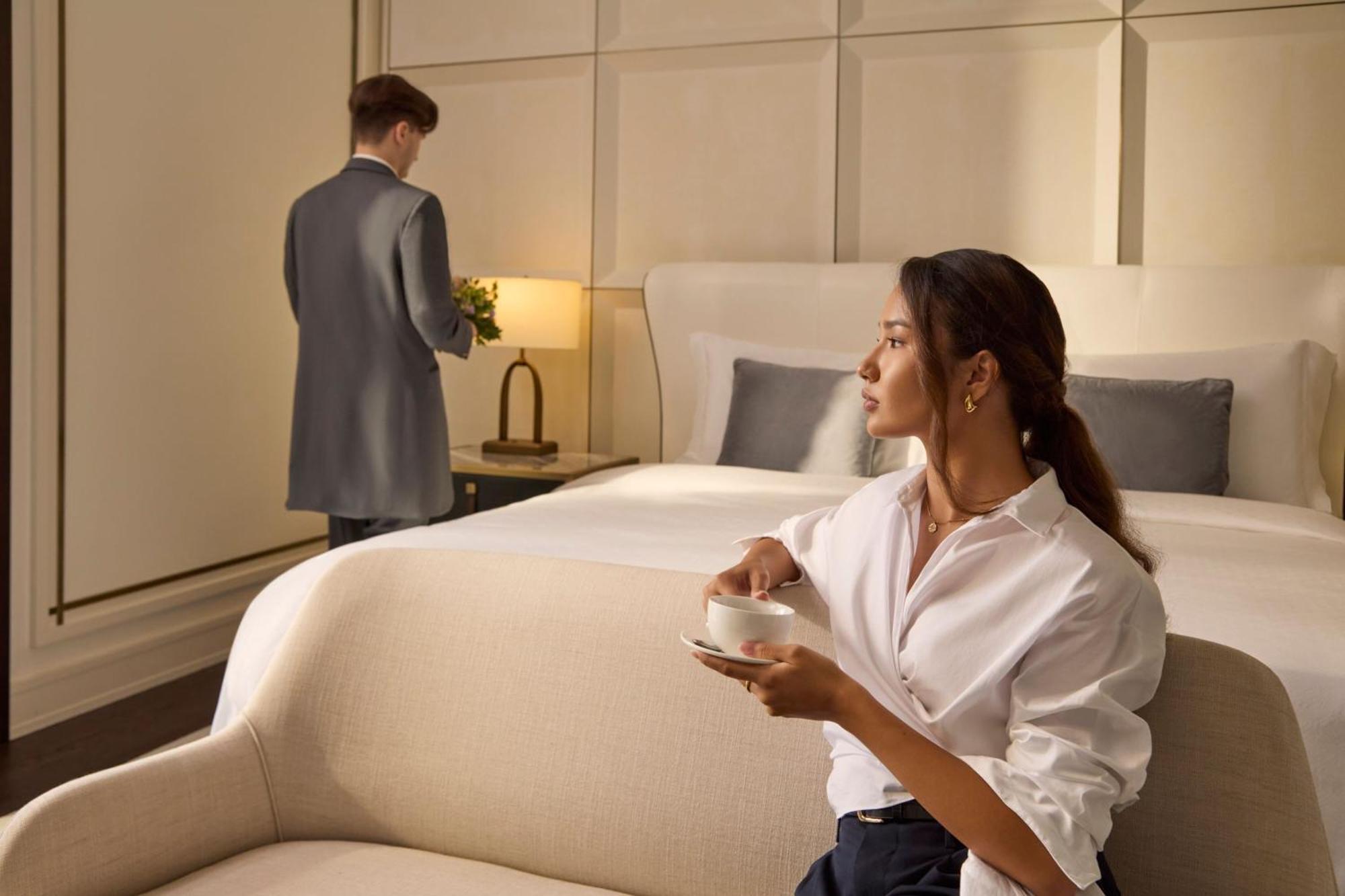 The St. Regis Astana Hotel Exterior photo A guest being served by a butler