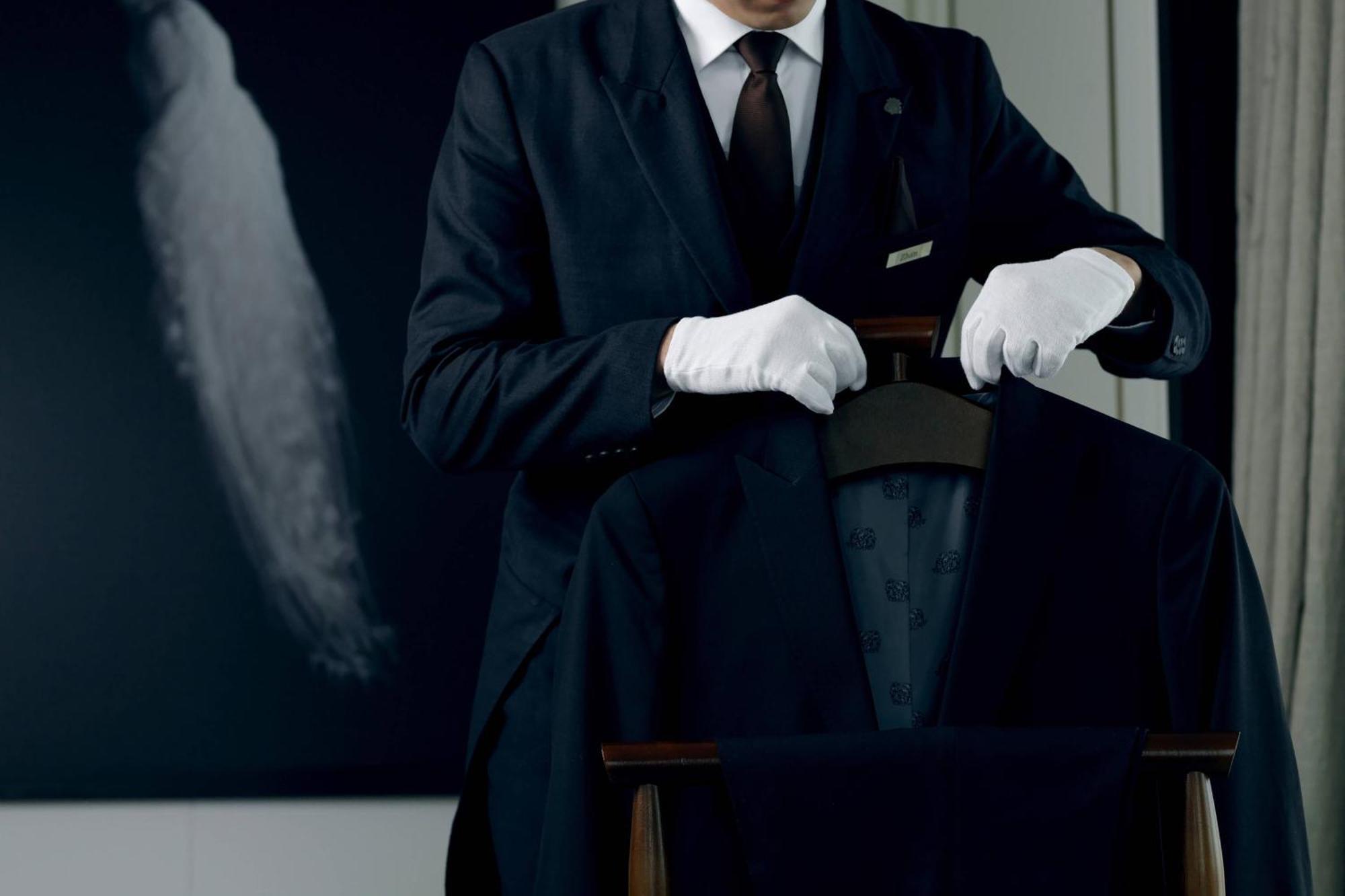 The St. Regis Astana Hotel Exterior photo A butler wearing white gloves