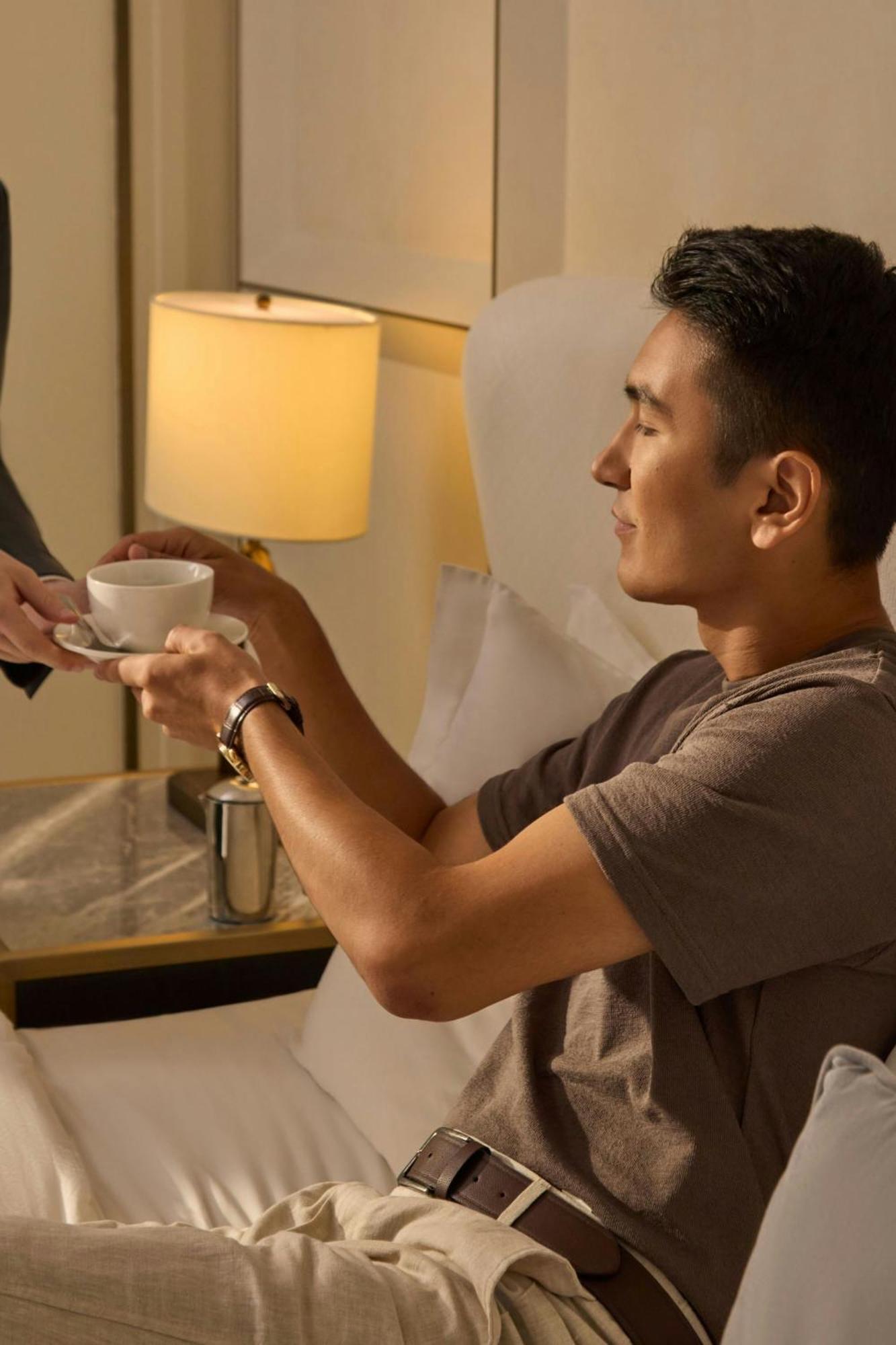 The St. Regis Astana Hotel Exterior photo A guest being served coffee