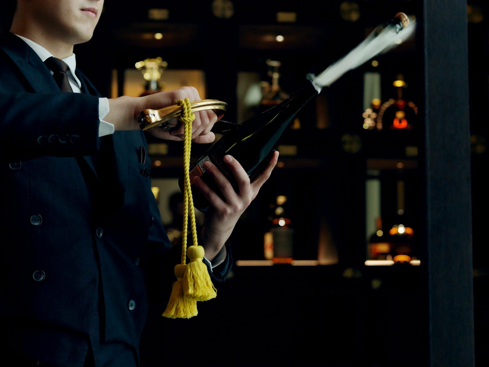The St. Regis Astana Hotel Exterior photo A wine waiter opening a bottle of wine